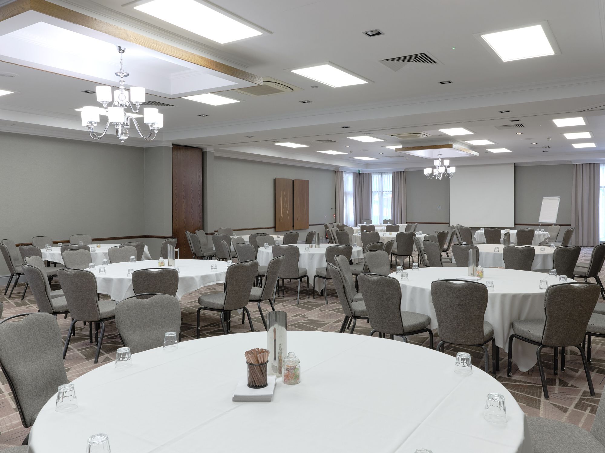 A large meeting room with round tables