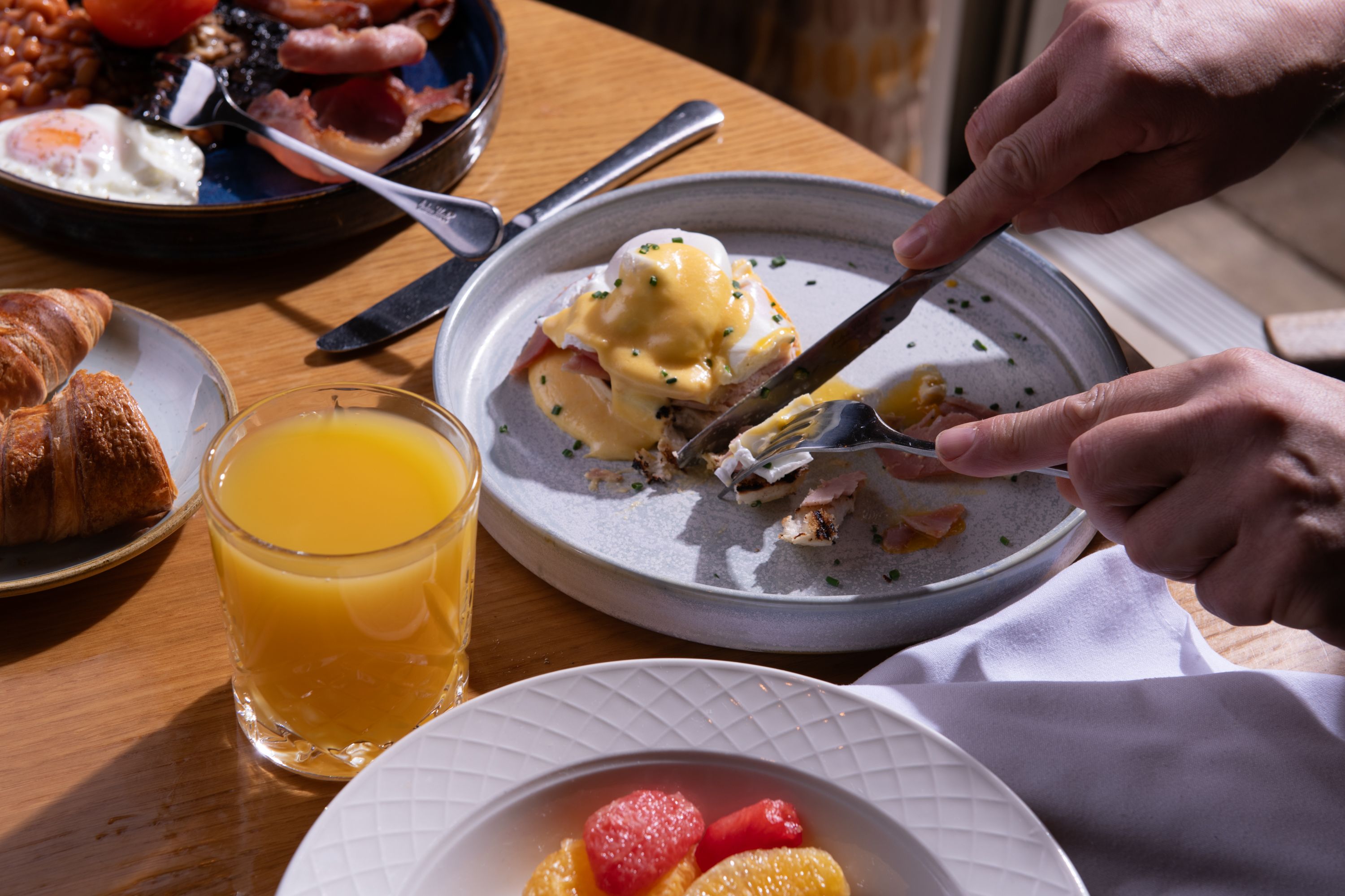 eggs benedict being eaten at a table